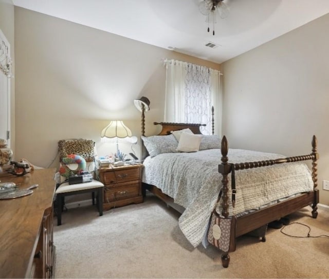 carpeted bedroom featuring ceiling fan and vaulted ceiling