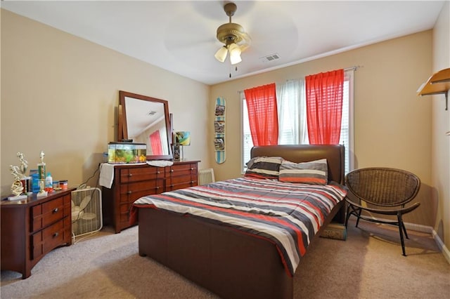 carpeted bedroom featuring radiator and ceiling fan