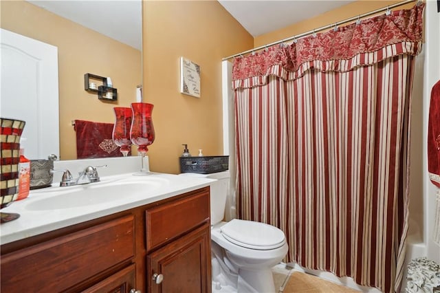 bathroom featuring curtained shower, tile patterned flooring, vanity, and toilet