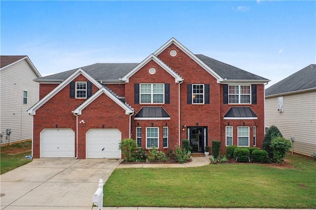 view of front of home with a front lawn and a garage