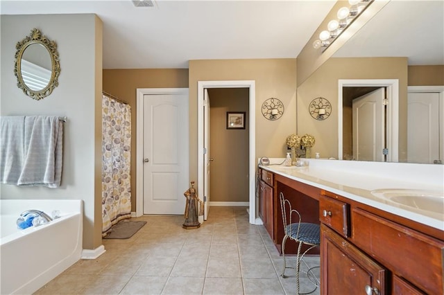 bathroom featuring tile patterned flooring, vanity, and a washtub