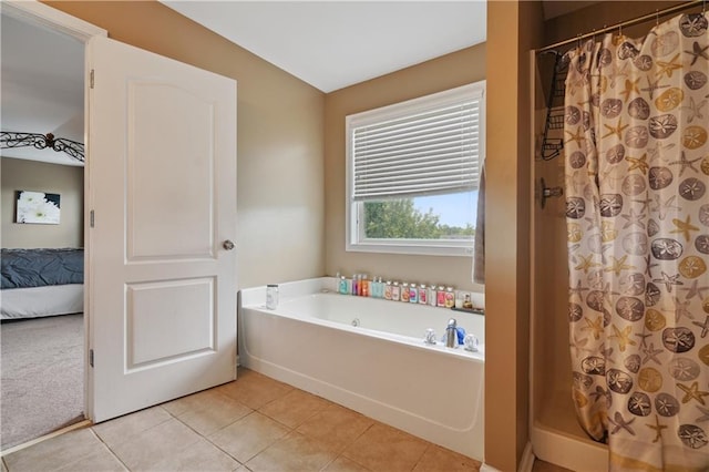 bathroom with tile patterned flooring and separate shower and tub