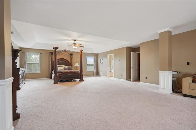 bedroom with multiple windows, ceiling fan, and light colored carpet