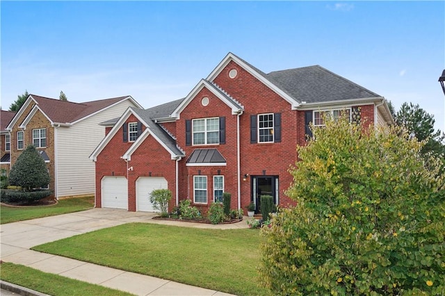 view of front facade with a front yard and a garage