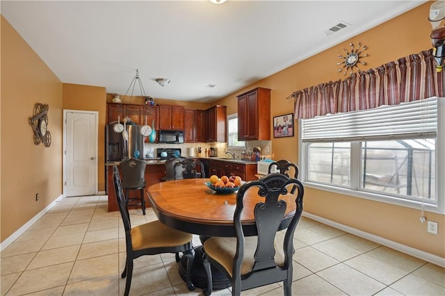 tiled dining space featuring sink