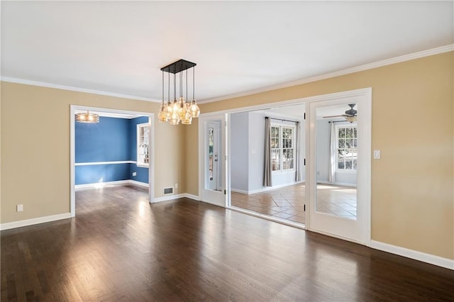 unfurnished room with baseboards, wood finished floors, and ornamental molding