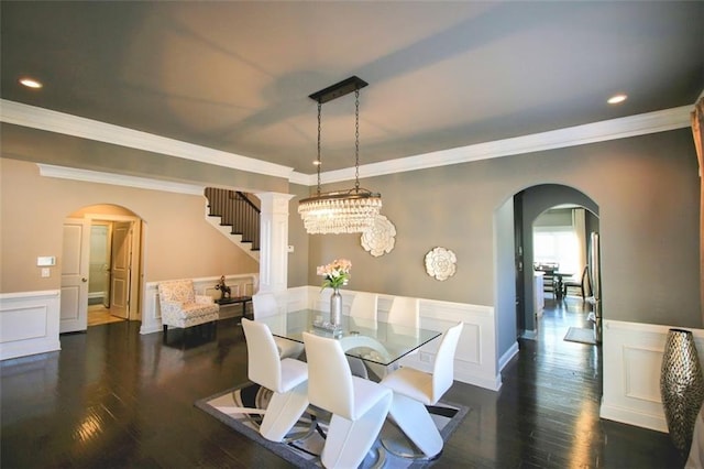 dining space featuring a notable chandelier, ornamental molding, and dark hardwood / wood-style floors