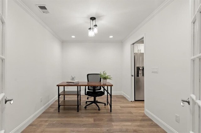 office area with light hardwood / wood-style floors and ornamental molding