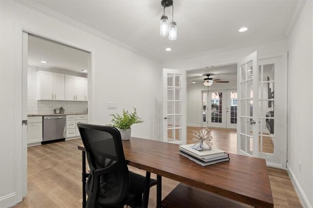 home office featuring crown molding, french doors, and light hardwood / wood-style flooring