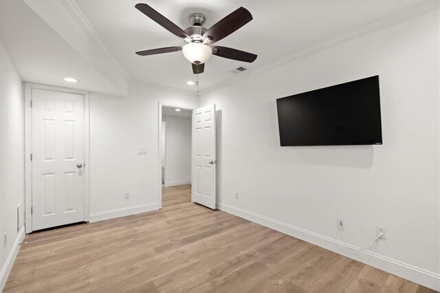 unfurnished bedroom with crown molding, ceiling fan, and light hardwood / wood-style flooring