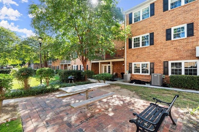 view of patio featuring central AC and a balcony