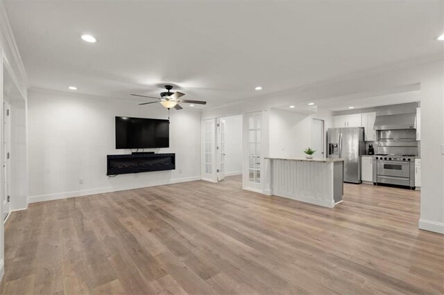 unfurnished living room with french doors, light hardwood / wood-style flooring, ornamental molding, and ceiling fan