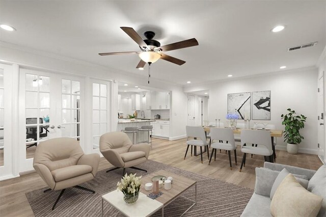 living room with ceiling fan, light hardwood / wood-style flooring, french doors, and ornamental molding