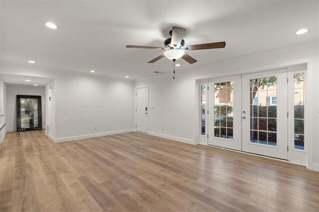 spare room featuring french doors, light hardwood / wood-style flooring, ornamental molding, and ceiling fan