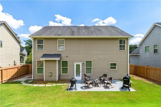 back of property featuring a yard and a patio