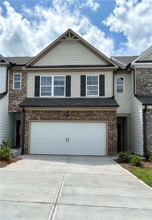 3853 Billabong Trl Unit 113, Gainesville, GA 30506 - view of front of house featuring concrete driveway, an attached garage, and brick siding