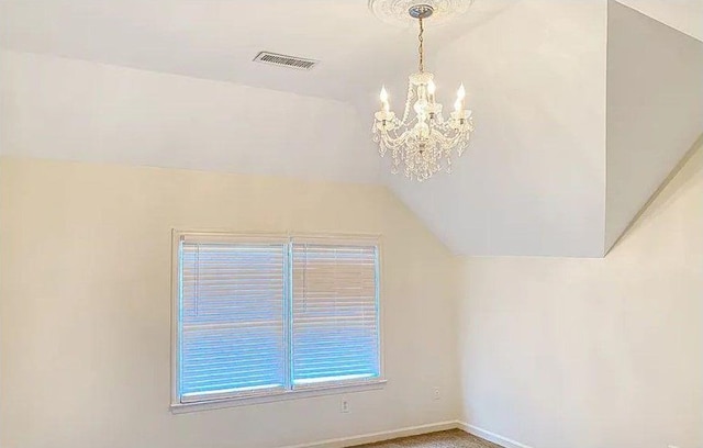 bonus room featuring visible vents, an inviting chandelier, carpet flooring, vaulted ceiling, and baseboards