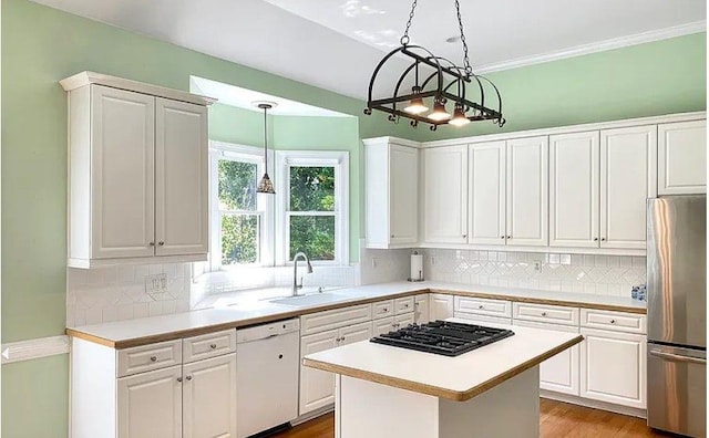 kitchen featuring freestanding refrigerator, white dishwasher, light countertops, a sink, and black gas stovetop