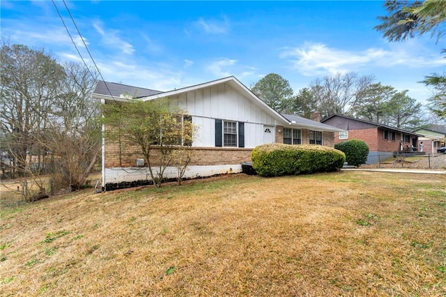 view of side of home with a lawn