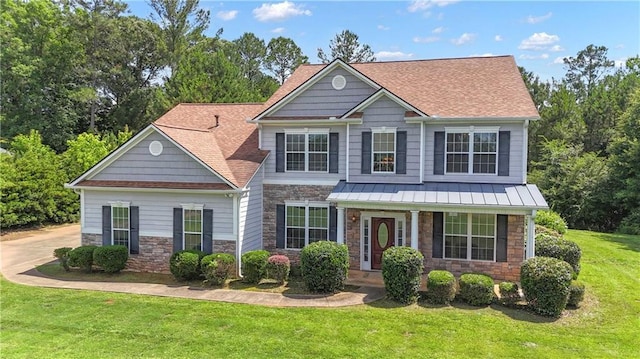 102 Plantation Dr, Lagrange, GA 30277 - view of front of home with stone siding, a front yard, and roof with shingles