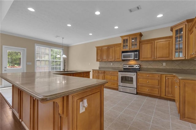 102 Plantation Dr, Lagrange, GA 30277 - kitchen with appliances with stainless steel finishes, brown cabinetry, recessed lighting, backsplash, and ornamental molding