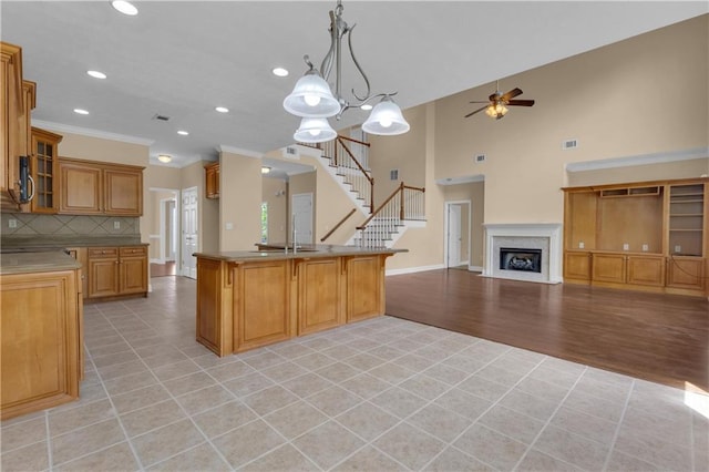 102 Plantation Dr, Lagrange, GA 30277 - kitchen featuring ceiling fan, light tile patterned floors, backsplash, brown cabinets, and recessed lighting