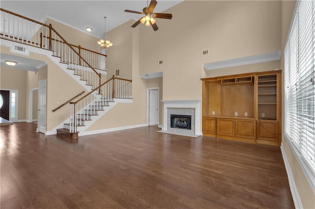 102 Plantation Dr, Lagrange, GA 30277 - unfurnished living room with a towering ceiling, healthy amount of natural light, stairs, ceiling fan, and dark wood finished floors