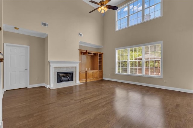 102 Plantation Dr, Lagrange, GA 30277 - unfurnished living room with ceiling fan, dark wood finished floors, a high ceiling, and a high end fireplace
