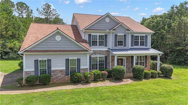 102 Plantation Dr, Lagrange, GA 30277 - view of front facade with stone siding, a front yard, covered porch, and roof with shingles