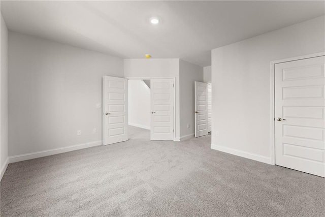 unfurnished bedroom with carpet flooring and baseboards