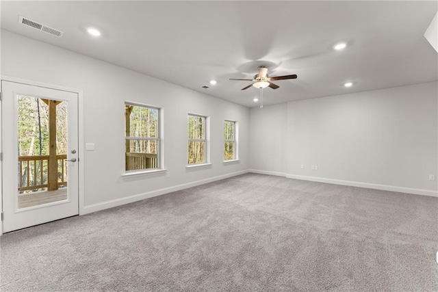 empty room with baseboards, recessed lighting, ceiling fan, and visible vents