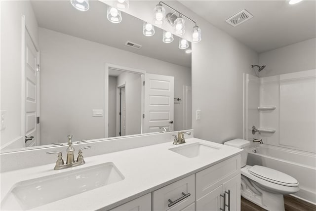 full bath featuring toilet, visible vents, and a sink