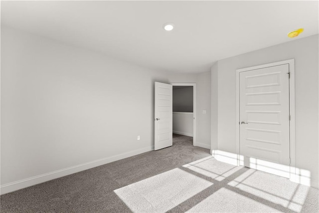unfurnished bedroom with carpet flooring, baseboards, and recessed lighting