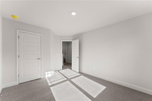 unfurnished bedroom with carpet floors, baseboards, and recessed lighting