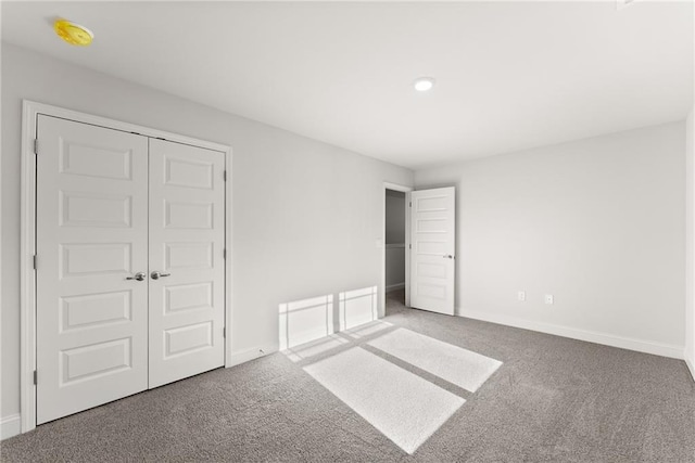 unfurnished bedroom with carpet flooring, baseboards, and recessed lighting