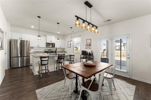 dining room with dark wood-style floors, visible vents, baseboards, and recessed lighting