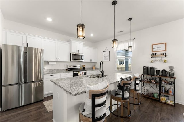 kitchen with white cabinets, dark wood-style flooring, stainless steel appliances, and a sink