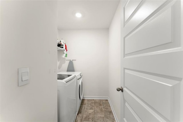 clothes washing area featuring laundry area, baseboards, and independent washer and dryer