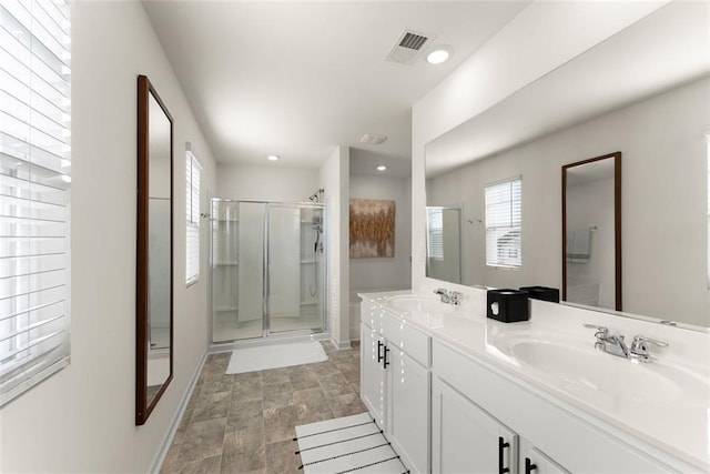 bathroom featuring recessed lighting, a sink, visible vents, double vanity, and a stall shower