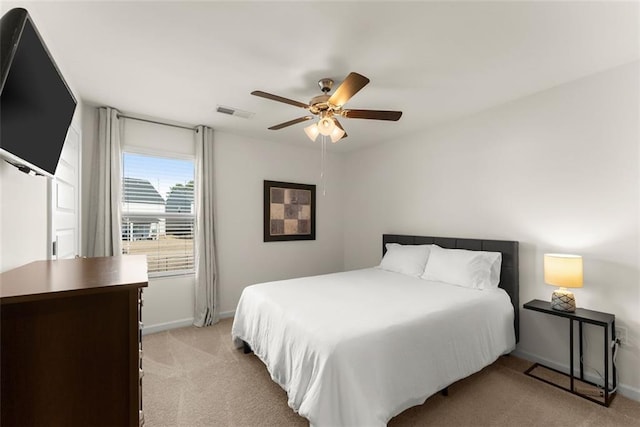 bedroom with baseboards, a ceiling fan, and light colored carpet