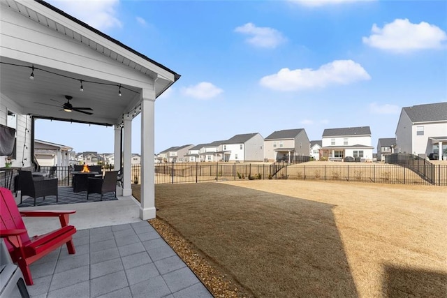 view of yard with a patio area, a fenced backyard, a residential view, and a ceiling fan