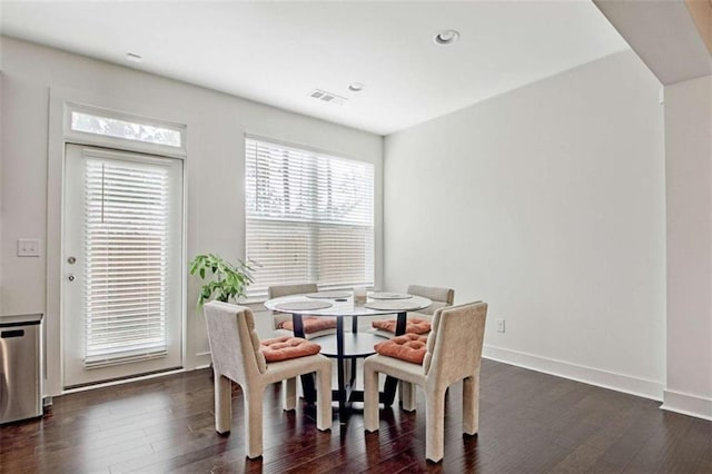 dining space with dark hardwood / wood-style flooring and a wealth of natural light