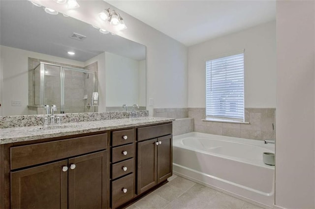 bathroom featuring tile patterned floors, vanity, and independent shower and bath