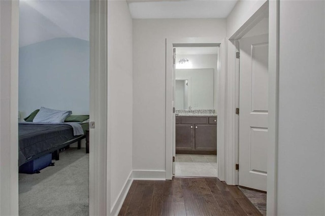 hall featuring hardwood / wood-style flooring and sink