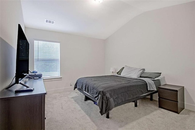 carpeted bedroom with vaulted ceiling