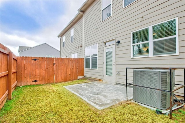 rear view of property featuring a patio area, a yard, and cooling unit