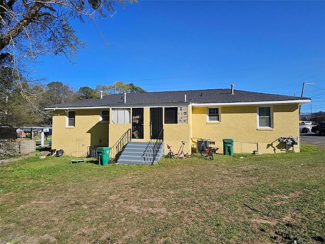 2795 Tilson Rd, Decatur, GA 30032 - rear view of property featuring brick siding, entry steps, and a lawn