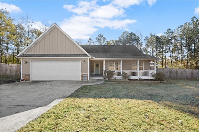 view of front of house with a porch, a front yard, and a garage