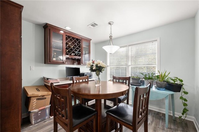 dining space featuring dark wood-type flooring