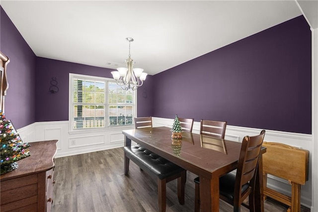 dining area featuring dark wood-type flooring and a chandelier